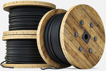 3 spools of black wire. One spool is leaning against the other two, which are stacked.